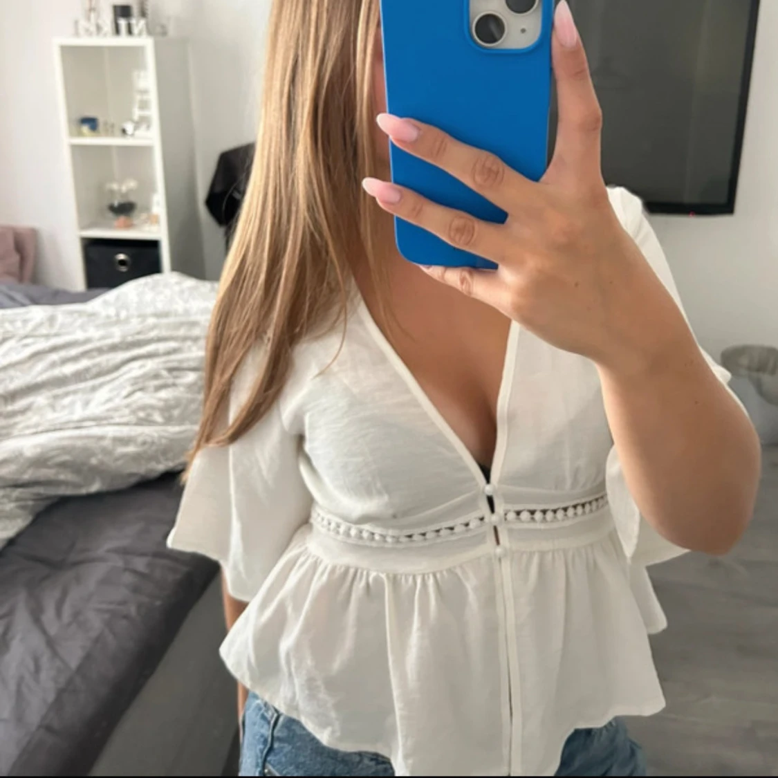 Vit blus med volang och v-ringning