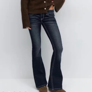 Mörkblå bootcut jeans med broderad fickor - mörkblåa jeans med snygga broderade fickor. aldrig använda bara tagit av lappen, exakt dessa jeans fast i tall🥰