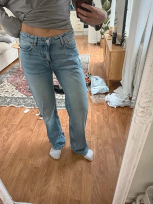 Ljusblå wide jeans low waist - Säljer ett par ljusblå jeans med low waist och wide fit. Jeansen har klassisk femficksdesign, dragkedja och knapp framtill. Perfekta om du gillar en avslappnad och trendig look med lite baggy känsla. Strl w27 l32