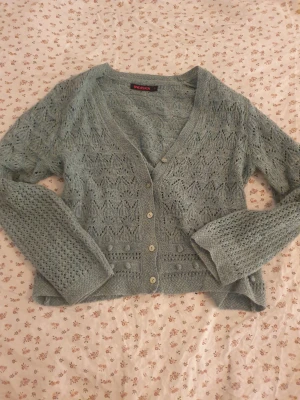 Luftig grön stickad kofta - Supersöt grön stickad kofta från Indiska i storlek M. Koftan har ett väldigt fint och luftigt mönster, perfekt för lite svalare sommardagar❣️