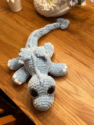 Ljusblå drake med silvriga ögon🩵 - Denna söta drake letar efter sitt nya framtida hem🐉🩵 Denna är virkad med kärlek, jag älskar att virka🩵 Den är virkad av mjukt garn från Rusta, hårda ögon som inte går att ta av. Den är cirka 54cm lång om man sträcker ut svansen🐉