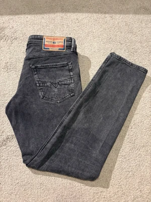 Diesel jeans W31 L32 - Mörkgråa Diesel jeans till grymt pris!! Väldigt fint skick, med snygg design på bakfickorna och på myntfickan. Använda väldigt få gånger. Mått 📐: Midja 43cm, Längd (midja-benslutet) 102cm.