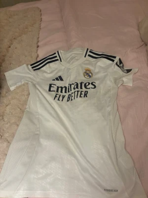 Real Madrid T-shirt ⚽️ - Säljer nu min real Madrid  T-shirt, i fint skick använd enbart några fåtal gånger. Den är såklart äkta och köpt i real Madrid shop 