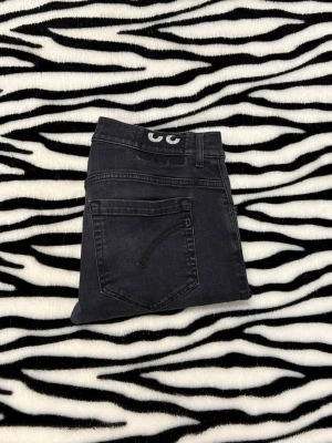 Dondup - Snygga grå jeans från Dondup med skinny fit och klassisk femficksdesign. Jeansen har knäppning med flera knappar fram och subtila slitningar för en cool look. Materialet är mjukt och stretchigt jeans, perfekt för dig som gillar smalare passform. Vid minsta fundering hör av dig 😀