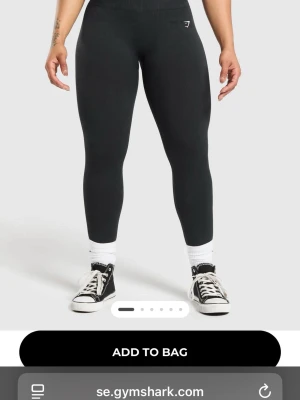 Svarta leggings från Gymshark - Säljer ett par svarta seamless leggings från Gymshark med hög midja och diskret logga på höften. De är tighta och har en ribbad midja som sitter skönt. Perfekta för träning eller chill. Materialet är stretchigt och mjukt, vilket gör dem riktigt bekväma. Det är helt nya inte använt dem en enda gång, det passade mig inte riktigt:( 