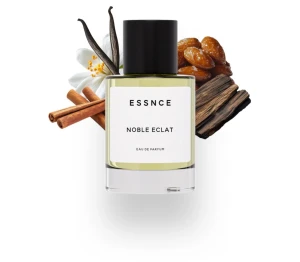 ESSNCE Noble Eclat Eau de Parfum - Modern parfym med stilren design från ESSNCE. Flaskan visar namnet Noble Eclat och Eau de Parfum. En söt, kryddig och varm vaniljdoft med öppning av kanel, kardemumma och citrus, ett hjärta av bourbonvanilj och elemi samt en djup, mjuk bas av mandel, tonkaböna, mysk och trä. Passar till både män och kvinnor – perfekt för dig som gillar Althair och liknande söta, kryddiga dofter. Oanvänd parfym, bortsett från lätt testspray. 