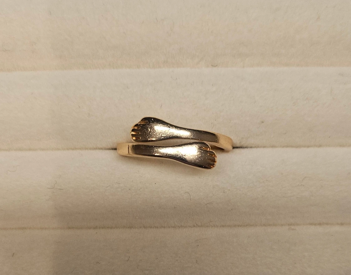 Guldfärgad ring med handdesign