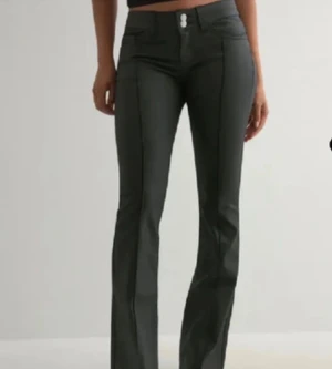 Svarta bootcut byxor med låg midja - Säljer ett par svarta byxor med bootcut och låg midja. Byxorna har två knappar framtill, klassiska fickor och markerade sömmar längs benen. Snygg passform som sitter tajt upptill och släpper vid vaden. Perfekta för dig som gillar en trendig siluett. Super snygga skinnbyxor i storlek S. De är använda 2-3 gånger men sparsamt använda så dem är i gott skick. Super sköna och bekväma även jätte snygga på. Passar till allt å dem är super fina. Nypris 700kr 