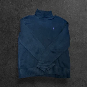 Ralph Lauren polo-neck tröja - strl M - Säljer en svart Polo Ralph Lauren polo-neck tröja i storlek M med lila märke på bröstet  👕 Märke: Polo Ralph Lauren 📏 Storlek: M 🎨 Färg: Svart (realistisk färg – se femte bilden) 📍 Skick: Mycket bra skick (se bilder)  💬 Har du några frågor är det bara att höra av dig! 💰 Vid snabb affär kan priset diskuteras. 📦 Skickar alltid inom 24 timmar!