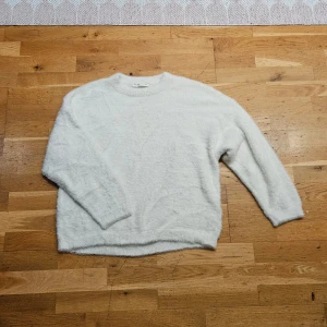 Fluffig stickad tröja - En riktigt fin vit fluffig stickad tröja från Pull & Bear, storlek S. Mjuk och fluffig, endast använd nån gång. 