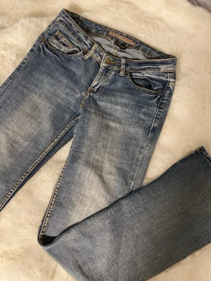 Mid/low waist jeans vintage - Säljer dessa jeans eftersom att de inte kommer till någon användning längre. De är i storlek 34 men skulle säga att de  även passar storlek 36. Jätte fina fickor och detaljer. Tecken på användning är längst ner på ena benet och lite slitning längst upp på jeansen (sista bilderna). Skulle säga att de är flared/straight. 