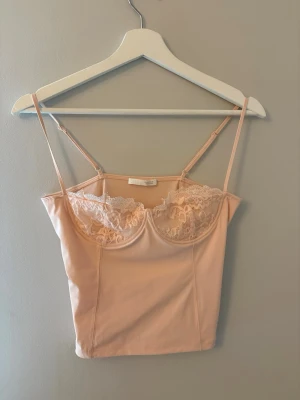 Beige linnetopp med spetsdetaljer Slutsålt - Superfint linne från Zara som inte säljs längre. Har tyvärr inte kommit till användning. Buda och ställ gärna frågor🩷 Storlek M men passar S mer skulle jag säga.