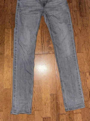 Gråa slim fit jeans, mid waist - Säljer ett par gråa slim fit jeans med mid waist och klassisk femficksdesign. Jeansen har raka ben och är tillverkade i ett mjukt denimtyg som passar perfekt till vardagslooken. Snygg tvättad grå färg som är lätt att matcha med olika stilar.