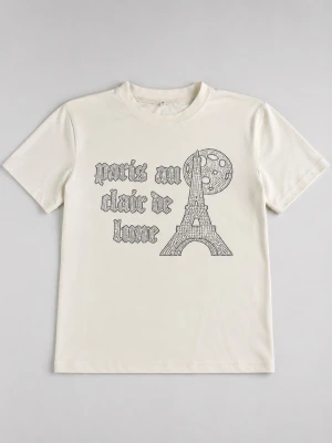 Vit t-shirt med Bling Lucid Paris-tryck - Säljer en Bling Lucid vit t-shirt med tryck av Eiffeltornet, måne och texten 'paris au claire de lune'. Klassisk rund halsringning och korta ärmar. Perfekt för dig som gillar grafiska motiv.