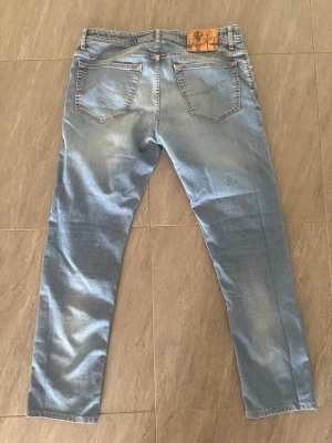 Ljusblå jeans från Jacob Cohen - Snygga ljusblå jeans från Jacob Cohen med raka ben och klassisk femficksmodell. Jeansen har kontrastsömmar i orange och en läderpatch med logga bak i midjan. Tillverkade i mjukt denimtyg som ger en avslappnad look. Längden är 30L. Skriv gärna vid frågor och funderingar, priset är ej hugget i sten 😊