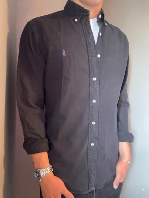 Svart Ralph Lauren skjorta – m slimfit  - Säljer denna stilrena och snygga svarta Ralph Lauren skjortan. Skjortan är i  mycket bra skick. Har du några frågor? Tveka inte att höra av dig. Allt got Deluxe Garderoben ⭐️ 