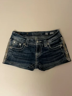 Miss Me shorts - Mörkblåa Miss Me shorts med detaljer. Inga besvär eller konstigheter utöver. Storlek 25 men passade mig som har storlek 34/S och passar nog för XS med. Skriv privat för funderingar eller frågor. 
