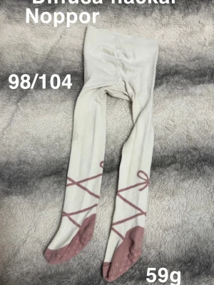 Vita strumpbyxor med balettdetaljer - Säljer ett par vita strumpbyxor med rosa balettinspirerat mönster och halkskydd under fötterna. perfekta för dig som gillar dansig stil.🌸 Diffusa fläckar. Noppor. Storlek 98/104