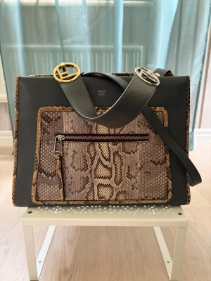 Fendi Runaway - Fendi Runaway Regular handbag in blue-grey smooth calf leather with natural python front panel and trim. Features a detachable top handle, detachable shoulder strap, front zip pocket and mixed gold- and silver-tone Fendi logo hardware.   Excellent condition with only minimal signs of use. Includes dust bag, shopping bag, authenticity card, care booklet and CITES documentation for the python leather.