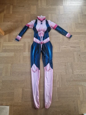 Ochako uraraka cosplay  - Säljer min Uraraka cosplay! Det är en hel bodysuit och har dragkedja i ryggen för att få på sig dräkten. Storlek XL, I längden passar det någon som är 175 cm. Bodysuiten är inte tight och den är stretchigt. Har använts 1-2 gånger och fötterna är lite smutsiga och det finns en fläck på dräkten. Katter finns i hemmet, hör gärna av dig om du har frågor 🫶! 
