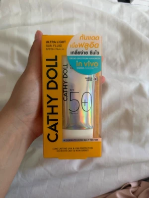 Cathy Doll Ultra Light Sun Fluid SPF50+ - Cathy Doll Ultra Light Sun Fluid SPF50+ PA++++ är en solskyddsfoundation i en holografisk tub på 40 ml. Produkten har en lätt, flytande formula som ger bredspektrigt skydd mot UVA och UVB utan att lämna vit hinna eller kännas fet. Förpackningen är gul och modern.