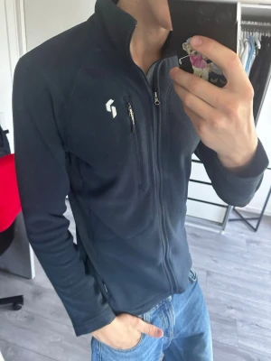 Mörkblå peak performance fleecetröja - Snygg och varm fleecejacka från Peak Performance i mörkblått. Perfekt som mellanlager eller för vardagsbruk och friluftsliv. 📌 Storlek: S 👕 Passar både dam och herr ✨ Fint skick, sparsamt använd 🔒 Hel dragkedja och praktiska fickor 🎨 Mörkblå färg