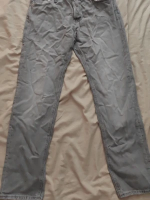 Grå jeans - Snygga grå jeans med rak passform och klassisk femficksdesign. Jeansen har normal midja och är tillverkade i ett mjukt denimtyg. Perfekta för dig som gillar en enkel och stilren look.