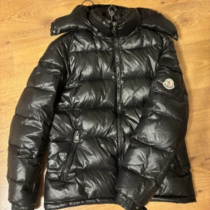 Moncler Jacka - en riktigt fet Moncler jacka. Den är i storlek 2/M men sitter lite mindre, några små skador framme på jackan som ni kan se på andra och sista bilden. Därav säljer jag billigt  Säljer för 2499 då nypris är ca 15,000kr intresse för byte mot en cardigan! Självklart äkta