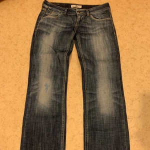 Lågmidjade jeans  - Ett par skit fräcka lågmidjade Jeans med dragkedja på bakfickorna. KÖPAREN STÅR FÖR FRAKTEN. 