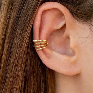 Golden Ear Cuff (no piercing) - Never worn! 4 bands conch ear cuff, two bands are beaded and the other two are smooth. Features: • No piercing hole needed. • Inner diameter: 10 mm. • Width: 9 mm. Only ONE available! • it is made of sterling silver (925 mm), and is gold plated in 18K • Nickel free
