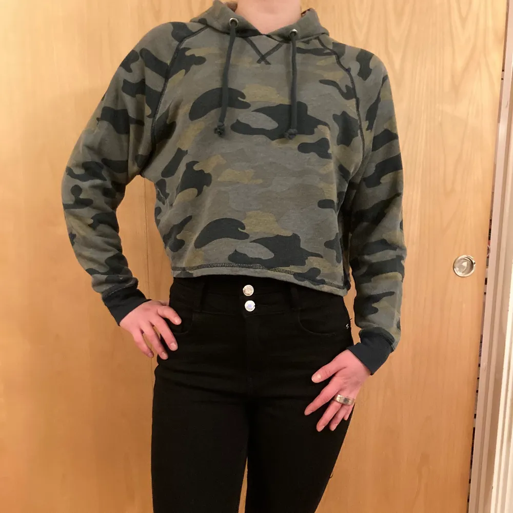 Camo colored crop top hoodie perfect to flash the belly on cooler summer nights. Good condition, worn only a handful of times. . Hoodies.