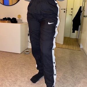 Nikebyxor - Ett par snygga o sköna, tunna nikebyxor med knappar i sidan och snöre i midjan! Storlek S! Sparsamt använda så i mycket bra skick! Köparen står för frakten (66kr) 🥰! 
