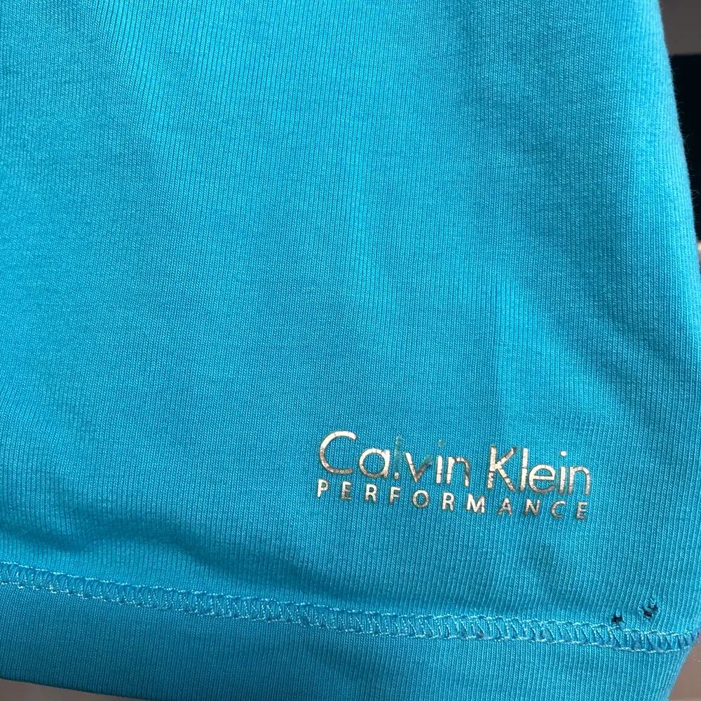 En superfin träningstopp från Calvin Klein. Den är använd ett fåtal gånger och har mest legat i garderoben. Såg nu när jag skulle fota att det fanns två små små hål längst ner på vänstra sidan. I toppen finns det en insydd sport-bh.. Toppar.