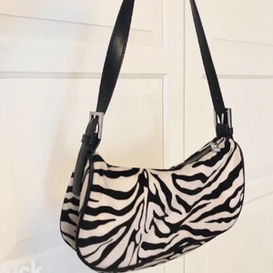 Zebra väska  - Zebra väska från Gina i mjukt material. Andra bilden är lånad det ingår INTE en kedja utan bandet som är på första bilden endast. Väskan är i nyskick. Frakt 62kr
