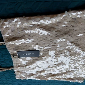 NEW! ONLY very light beige sequined top - Brand new top from Only. Never worn, with price tags in place.  Clean, no defects.  Beautiful beige semi-gloss sequins on the entire front. Delicate plain fabric on the back.  Prolonged back.   Fabric: 100% polyester.   Size: M/L (for loose fit / closer to body).