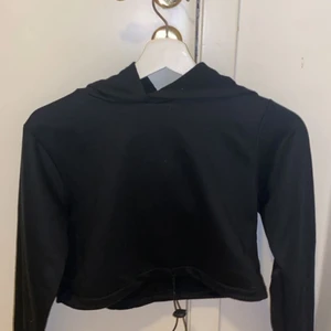 Croppad svart hoodie - Den är lika kort i magen som en magtröja och är ifrån boohoo, skulle lätt funka som tränings tröja