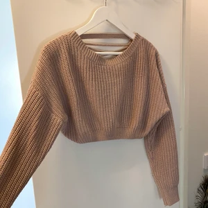 Stickad tröja - Älskar den här stickade tröjan!! Men kommer tyvärr aldrig till användning då jag har flera liknande. Jätteskönt material, långa ärmar, croppad, snygg detalj i ryggen 👌🏼 Lite svårt att fånga färgen på bild, men skulle säga att den är liite mer rosa än vad det ser ut som!  Köparen står för frakt 🌸