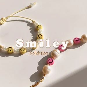 Smiley armband - En ny kollektion kommer nu med glada smycken!😋  Först ut har vi två armband. Det rosa armbandet med sötvattenspärlor fästs med en hake i guldig metall. Det gula armbandet reglerar du storleken med hjälp av att dra i två snören.   Standardstorleken är barn/dam men jag kan göra önskad längd❣️  Passar fint att bära tillsammans eller för sig💛💗