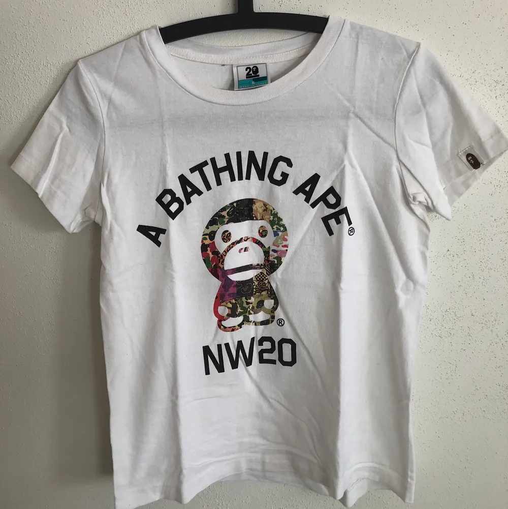 Women’s Bape / A Bathing Ape Baby Milo 20th Anniversary T-Shirt  Size small, women’s fit.  Great condition, no flaws or damage.  DM if you need exact size measurements.   Buyer pays for all shipping costs. All items sent with tracking number.   No swaps, no trades, no offers. . T-shirts.
