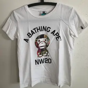 Women’s Bape / A Bathing Ape Baby Milo 20th Anniversary T-Shirt  Size small, women’s fit.  Great condition, no flaws or damage.  DM if you need exact size measurements.   Buyer pays for all shipping costs. All items sent with tracking number.   No swaps, no trades, no offers. 