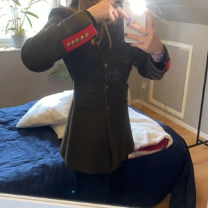 Jacka / Kappa - Kort jacka/kappa i brun (typ jord) färg från Zara woman. Köpt för några år sen, helt felfri förutom etiketten vid nacken. Påminner lite om sovjet/ryssland. Två fickor! Och sitter som en tratt, går in vid midjan men sedan utåt. Har typ vadderade axlar.