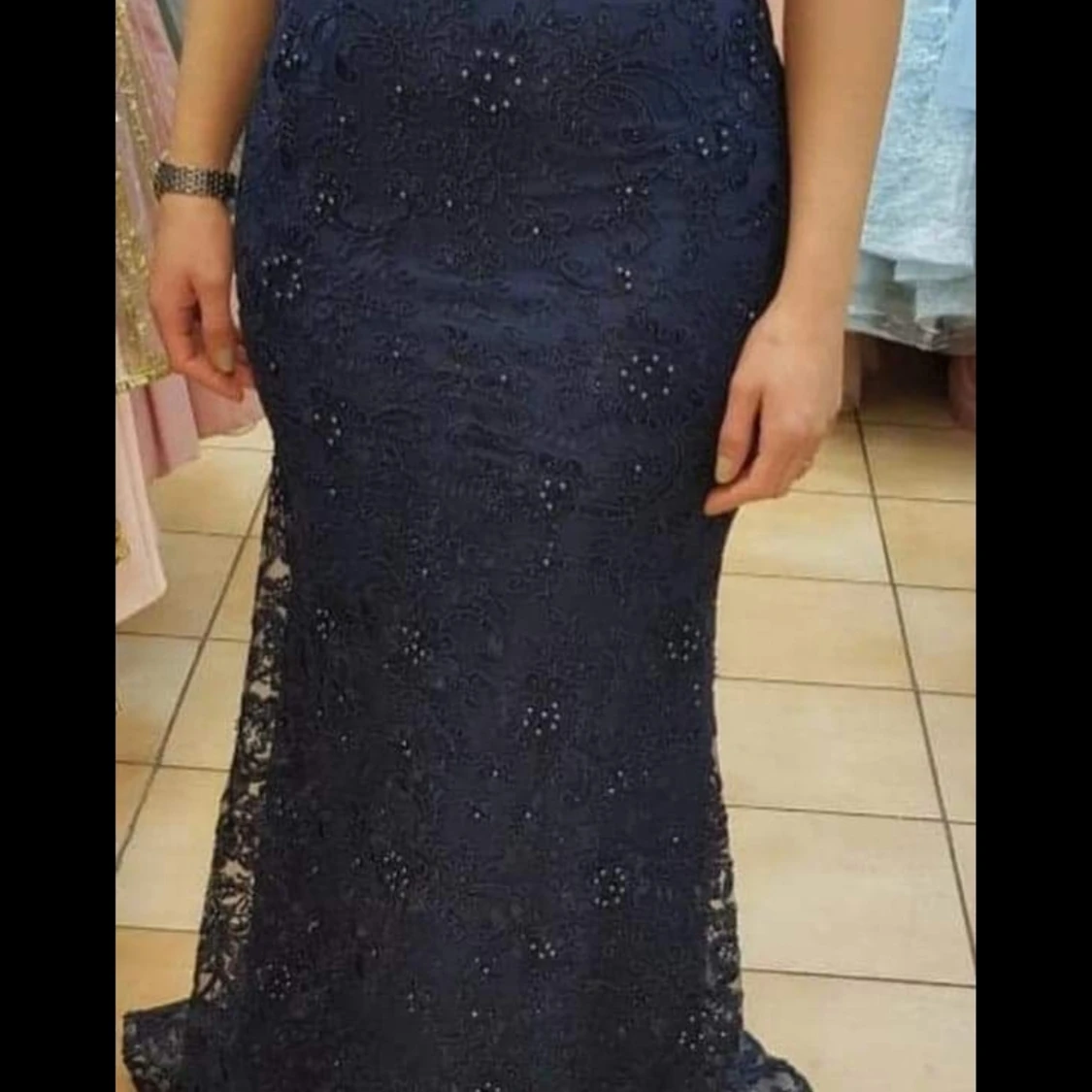 En supersnygg tight klänning i mörkblå med fina detaljer över hela plagget. 