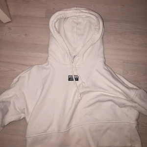 Vit Croppad hoodie från adidas  - En croppad vit hoodie med luva från adidas. Med svarta detaljer,  Storlek S. Använd några gånger men nästan nyskick. 