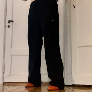 Oversized Nike vindbyxor - Så snygga oversized 90s inspirerade Nike byxor!! Faller så snyggt och är supersköna! Har lite småfläckar längst ner men de syns knappt. Lappen är avklippt så vet inte vad för storlek men sitter översized på mig som brukar ha M i byxor.