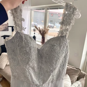 Oanvänd balklänning storlek xl (passar l med stor byst) - Jättefin oanvänd balklänning i färgen silver med prislapp kvar, enbart testad. Paljetter i övre partiet både fram & ryggen! Det är en långklänning.  Säljer den då min bal blev inställd & jag inte kommer att ha något annat tillfälle att bära den.  Nypris var 3000kr Storlek xl men passar l också