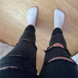 Svarta skinny ankle denim H&M med hål - Svarta håliga jeans från H&M, lite stora i storleken