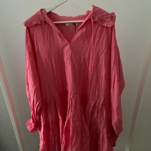 Rosa klänning  - Rosa lite oversized klänning med lång ärm och snörning längst upp! Jättefin och går ner till mitten av låret på mig (167cm) använd en gång! Inköpspris 599kr
