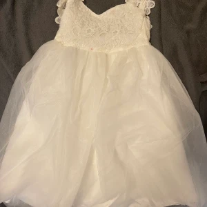 Vit barnklänning  - Använd en gång, har en liten fläck, går att tvätta bort. Frakt ingår, möter inte upp. 