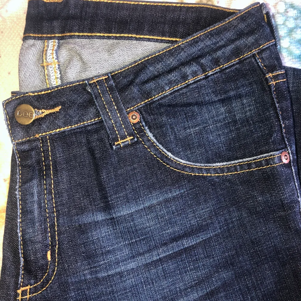 Mörkblåa bootcut jeans från Lee i M typ, hittar inte exaxt storlek i de. Superbra skick, passar de som är kanske 155 cm!. Jeans & Byxor.