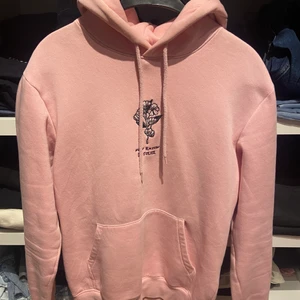 Hoodie - En rosa hoodie från hm herravdelning i storlek XS men passar mig som oftast bär S-M. Den har 2 små röda fläckar från en penna bak på armen men som knappt syns.